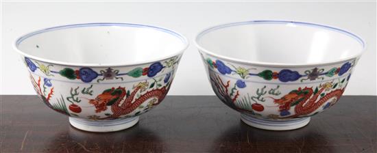 A pair of Chinese wucai dragon and phoenix bowls, Qianlong seal marks, late 19th/early 20th century, 18cm, small rim chips